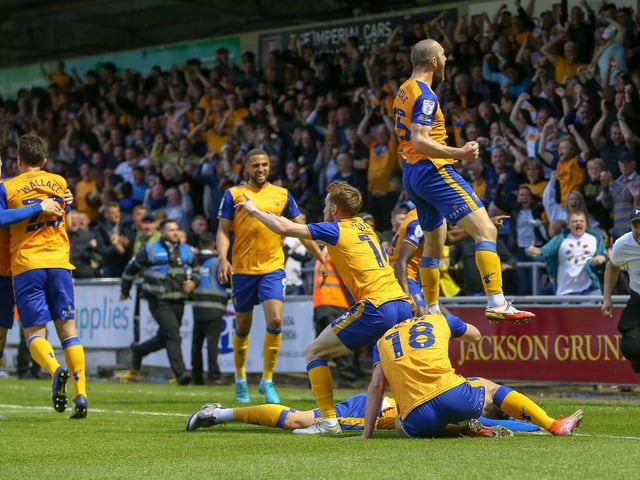 The team celebrates their first half goal in front of the travelling Stags fans.