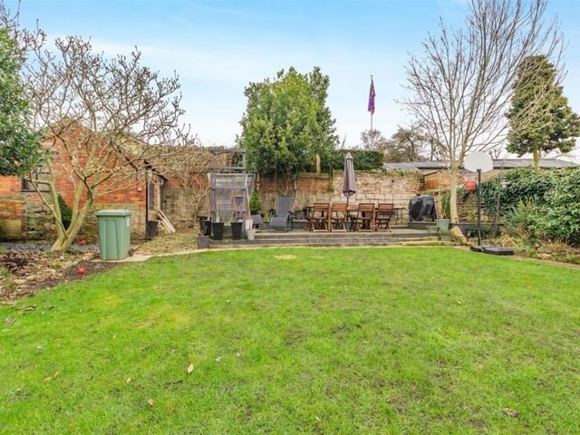 At the bottom of the lawn in the rear garden sits an extensive decked patio.