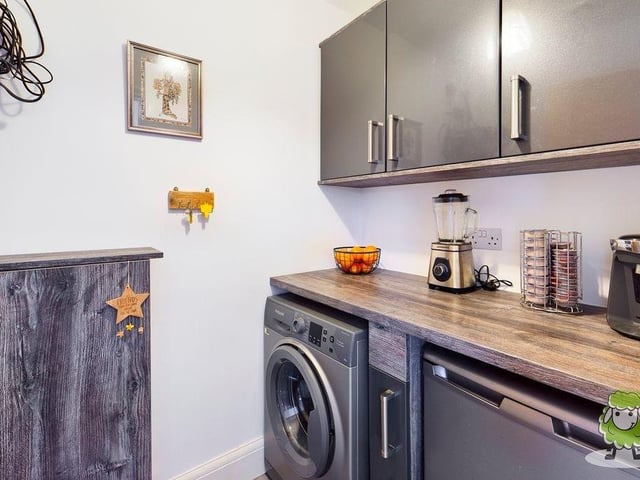 This utility room is accessible from the open-plan area. It has space and plumbing for a washing machine.