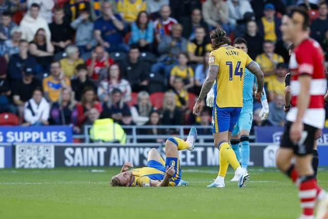 Alfie Kilgour lies injured during the Sky Bet League 2 match against Doncaster Rovers FC at the Eco-Power Stadium  
Photo Chris & Jeanette Holloway / The Bigger Picture.media