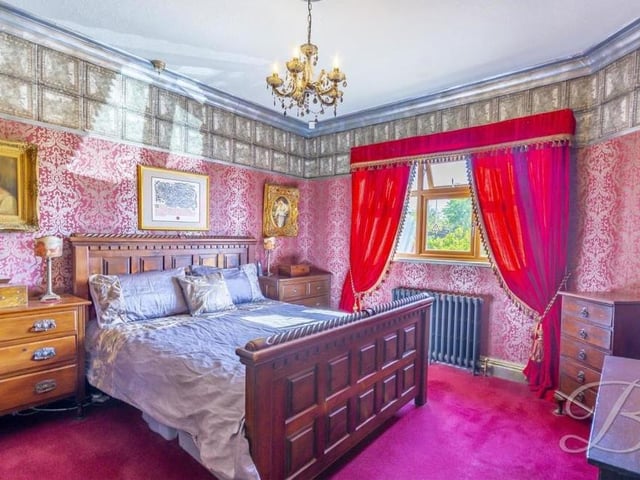 Moving on to the bedrooms now, and this first one would not look out of place in a regal palace. With carpet to the floor and coving to the ceiling, it has a cast-iron radiator and a window to the side of the bungalow.