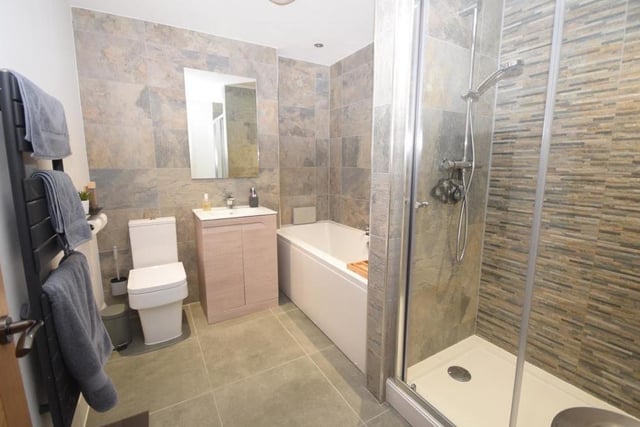 The modern family bathroom on the first floor has a bespoke design. Its quality suite consists of a double-ended bath, separate shower cubicle with dual showers, wash basin in a vanity unit and low-flush WC. There is also a heated towel-rail and tiled floor.