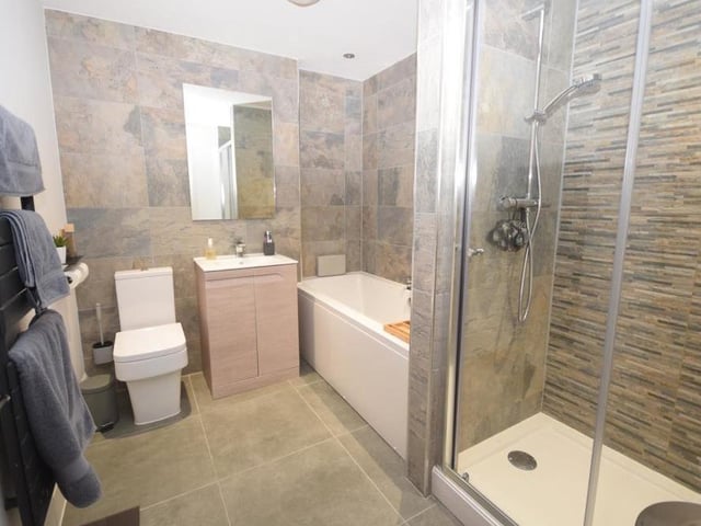 The modern family bathroom on the first floor has a bespoke design. Its quality suite consists of a double-ended bath, separate shower cubicle with dual showers, wash basin in a vanity unit and low-flush WC. There is also a heated towel-rail and tiled floor.