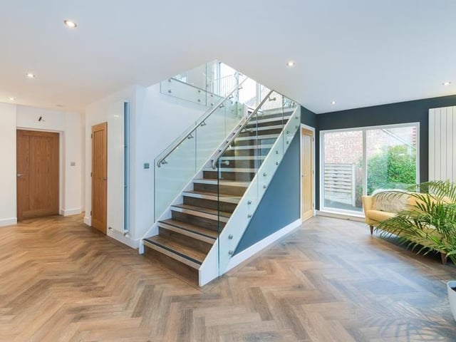The entrance hall features the staircase that leads to the first of three floors at the Burton Joyce property.