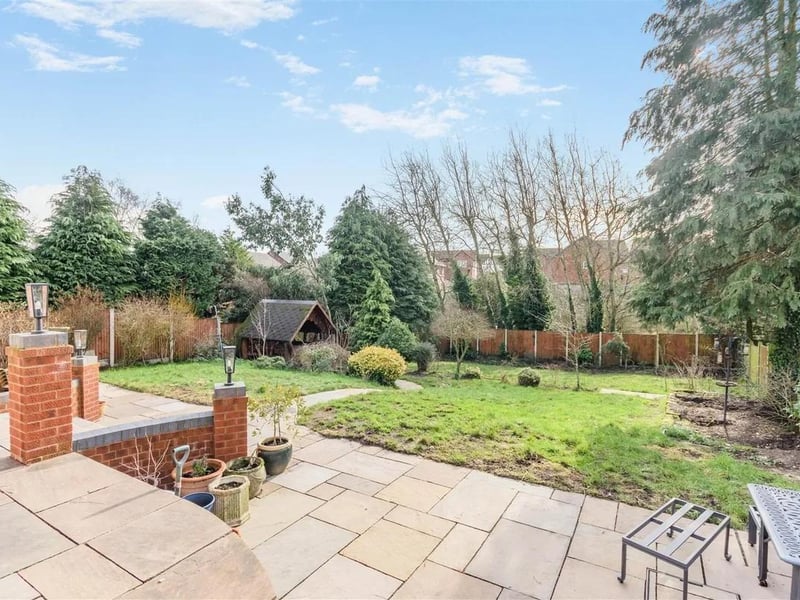 To the rear of the property, there is a large, south facing garden featuring a substantial Indian sandstone patio on two levels which extends across the full width of the property with ample brick wall features with light fixtures on top.