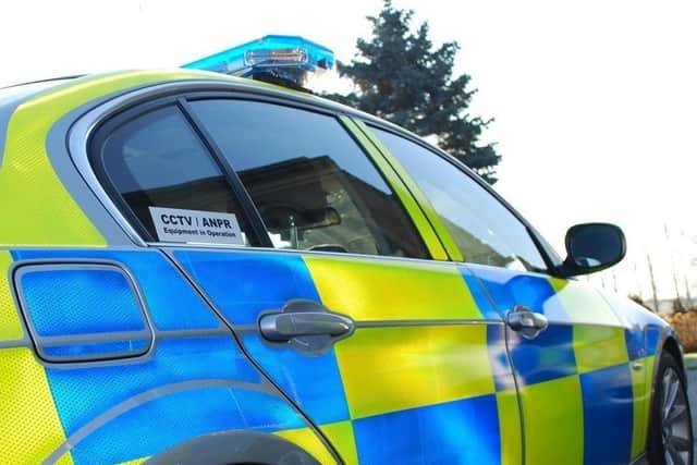 Three men have been arrested after a police car was rammed by a van in Sutton on Sunday afternoon.
