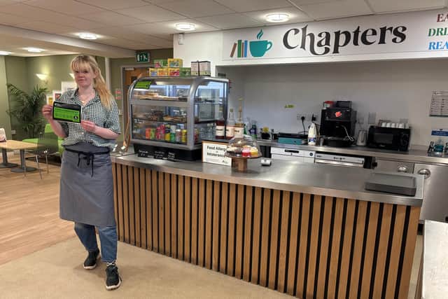 Maddy Stanton pictured with their 5 star Food Hygiene Rating in their new cafe Chapters