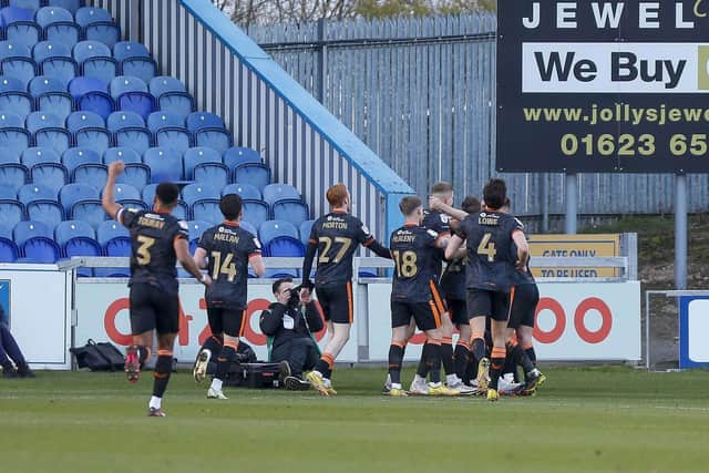 Matty Lund and team mates celebrate after he netted his side's fourth and decisive goal at the One Call Stadium on Saturday. Photo by Chris Holloway/The Bigger Picture.media