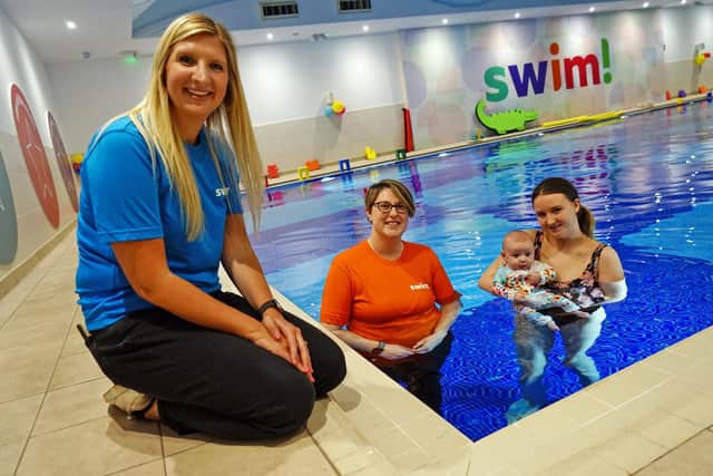 Rebecca Adlington returns to Mansfield to officially open the new Adlington-backed beginners' 'swim!' pool on Portland Retail Park - seen talking to swim teacher Becky Daley and parent Katy with baby Raya.