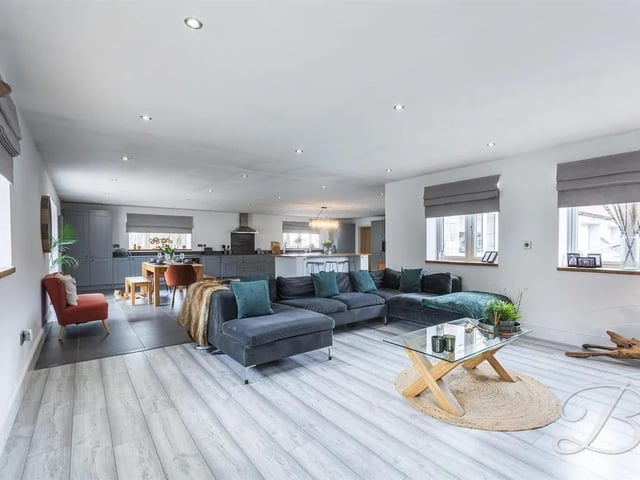 The entire room is bright and airy, thanks to an abundance of surrounding windows and impressive bi-folding doors to the front elevation, which flood the space with natural light and create a seamless flow to the outdoors.