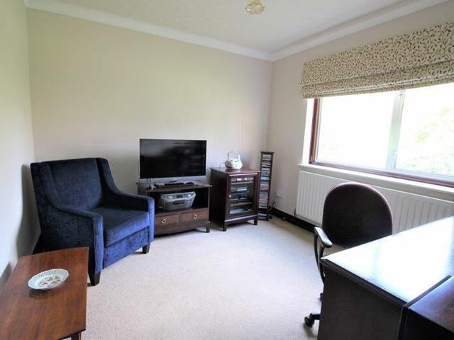 This bedroom can easily be converted into an office or study.