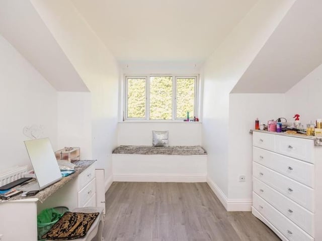 This neat and practical bedroom could easily be converted into office space or a study.