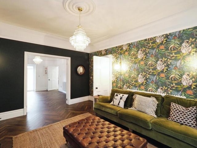 A notable feature of the High Oakham Road property throughout is the way it has been distinctively decorated. It is evident in this second shot of the lounge, which has double doors leading into the dining room or play room.