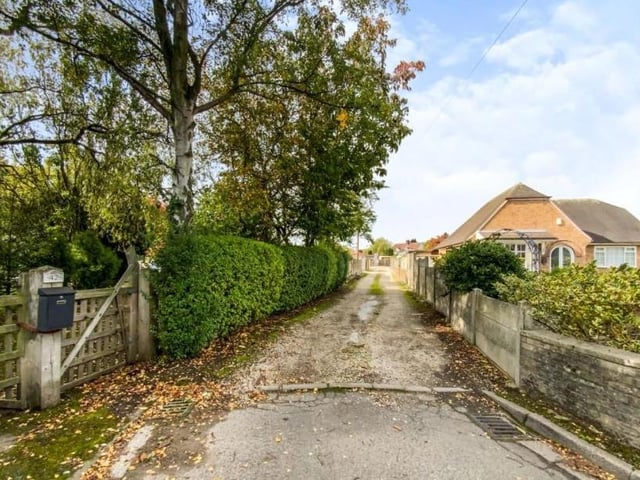 The long, private driveway that leads to the bungalow has a decidedly rural feel to it.