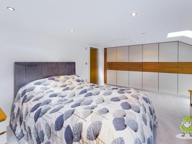 The master bedroom can be found on the second floor of the three-storey building. It includes extensive, fitted wardrobes and access to an en suite shower room.