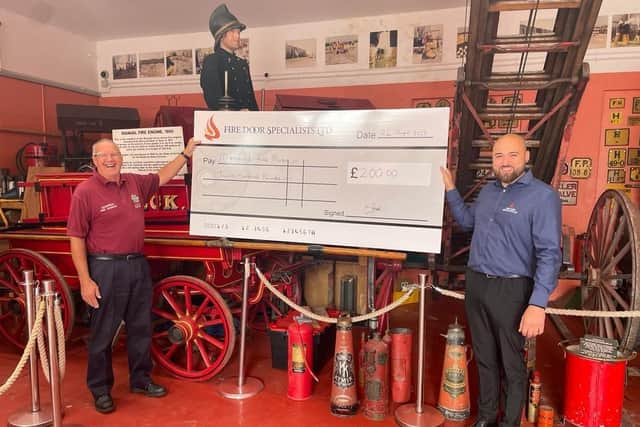 Paul Davidson, of Mansfield Fire Museum, receives a donation of £200.