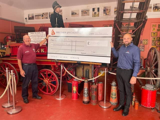 Paul Davidson, of Mansfield Fire Museum, receives a donation of £200.