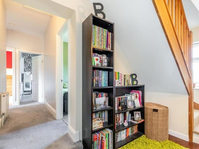 The first-floor landing leads the way to four of the other five bedrooms. The staircase to the right gives access to the final bedroom on the second floor.