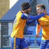 James Perch celebrates with goal scorer Rhys Oates at Oldham Athletic.