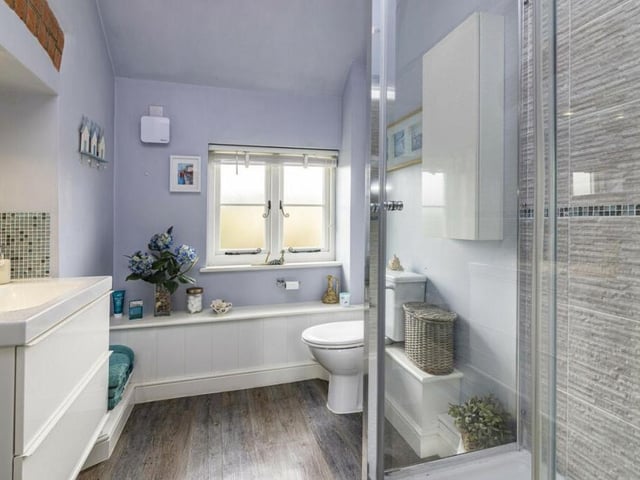The property has a toilet downstairs, but this is the main shower room on the first floor. A stylish suite, it includes a shower cubicle, wash basin and WC.