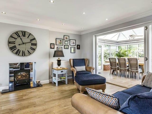 The first of two spacious reception rooms to take a look at is this splendid sitting room, with its feature fireplace and traditional log-burner. Bi-folding doors lead to the conservatory.