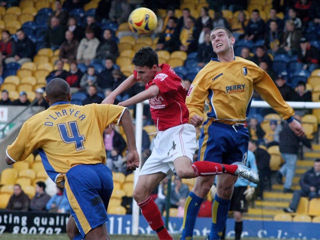 John D'Laryea and Jake Buxton battle for the ball.