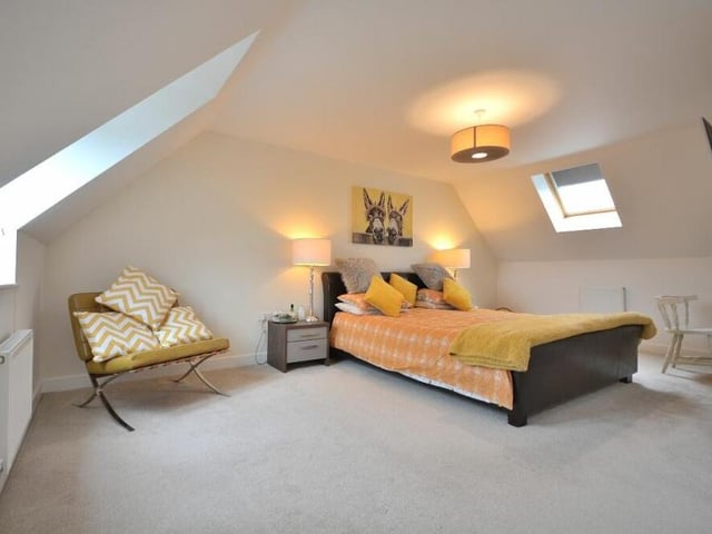 Although on the top floor, the master bedroom is filled with natural light thanks to three double-glazed windows to the front and back of the house.The front outlook gives views over open fields.