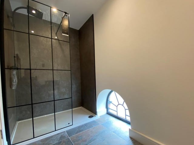 This superb en suite oozes modern style. The walk-in shower cubicle is complemented by a wash hand basin and low-level WC
