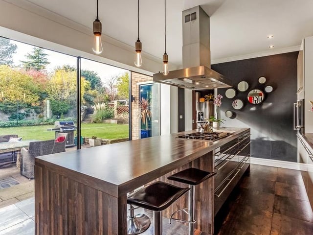 Modern and stylish is the best way to describe the kitchen, which is distinguished by its huge sliding glazed doors that lead to the patio in the back garden. The room is well appointed, with a central island and Gaggenau appliances that include a six-ring gas hob with extraction unit, built-in steam oven, self-cleaning oven and warming drawer.