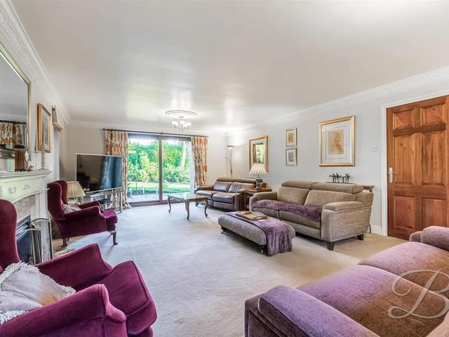 This expansive reception room with a feature fireplace is the perfect place to enjoy warm and cosy family evenings.