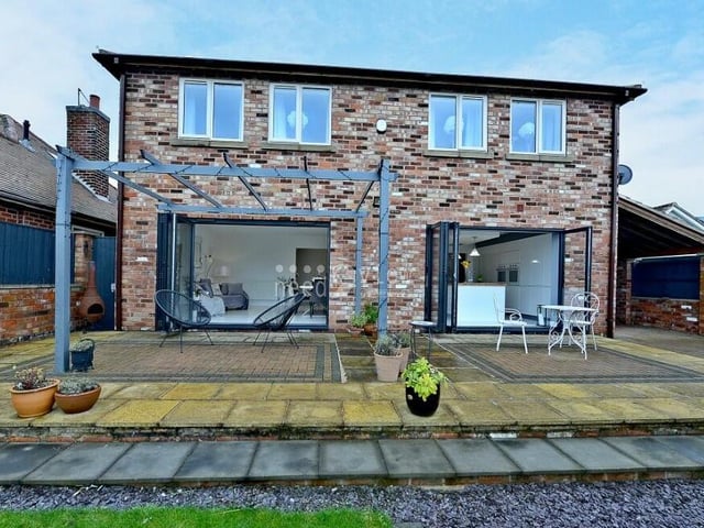 This image shows how the house is well served by its two pairs of uPVC double-glazed bi-folding doors on the ground floor. One opens out from the dining area and one from the kitchen.