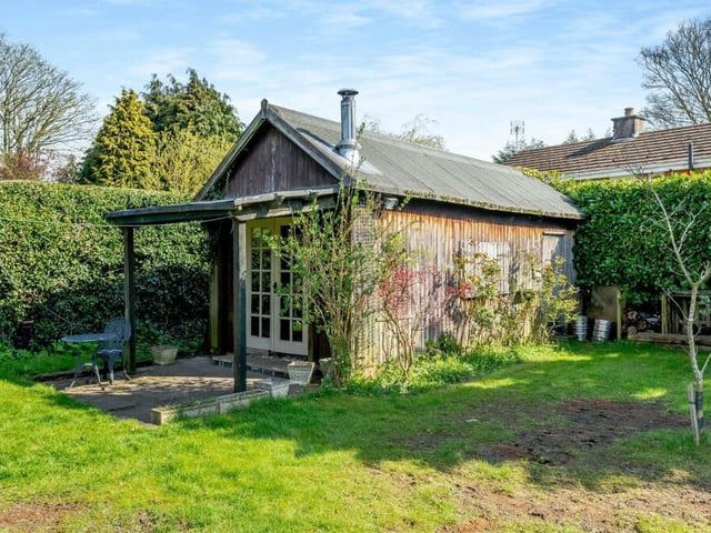 A major bonus feature of the back garden is this garden room, currently being used as a games room with a bar.