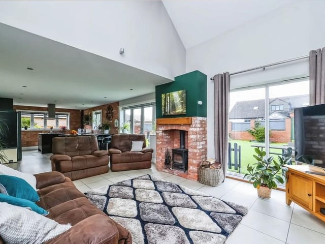 The open plan living/ dining room with vaulted ceiling and views over the garden.