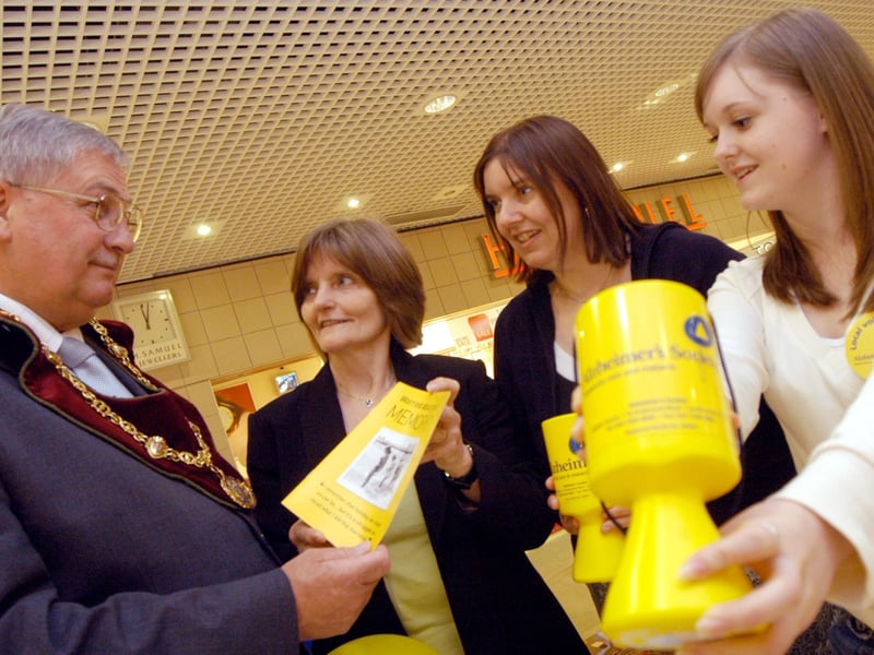 Coun Barry Answer former chairman of MDC visits the Alzheimer`s Society stall in the Four Seasons shopping centre. Also in the picture from the left are Pam Andrews Chairman of the Mansfield and Ashfield branch, Carol Dudley Volunteer and Caitlin Dudley, volunteer. Year: 2007