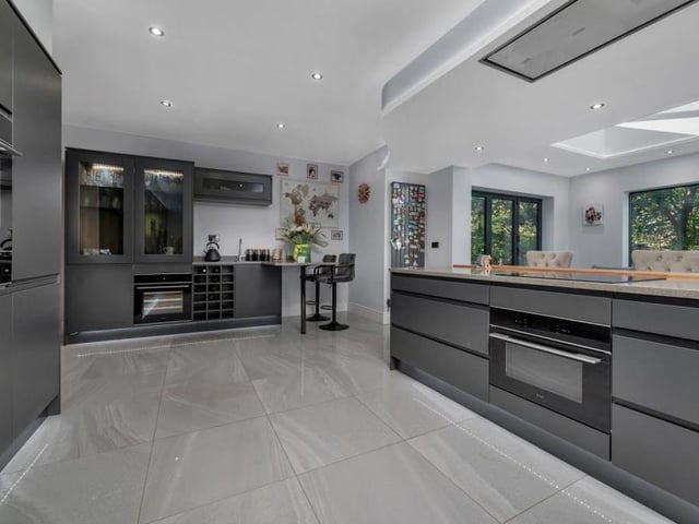 Next stop is the open-plan living kitchen, which is a superb, contemporary room, completed as recently as May last year. It features a range of anthracite, dark grey cabinets in a matt finish, with wall cupboards, display cabinets, base units, drawers and quartz worktops. An L-shaped peninsula breakfast bar island has matching quartz worktops.