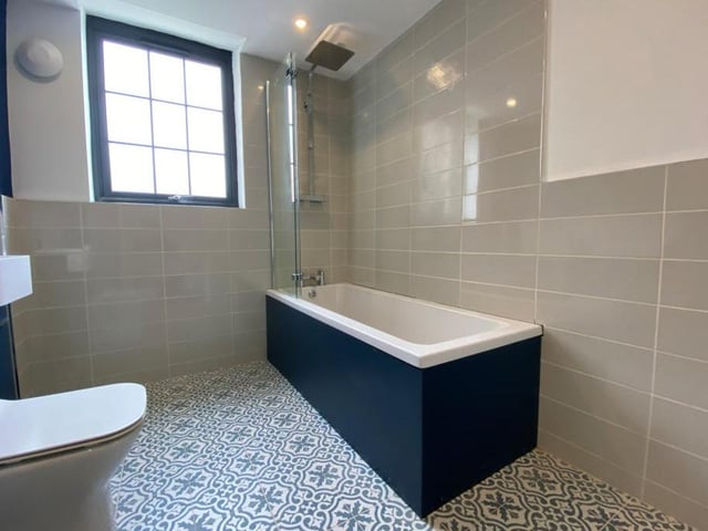 The family bathroom on the ground floor consists of a three-piece suite, with a double-glazed window to the side of the house.