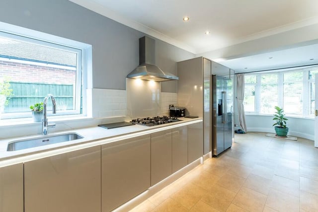 The dining kitchen boasts a range of integrated appliances, as well as underfloor heating.