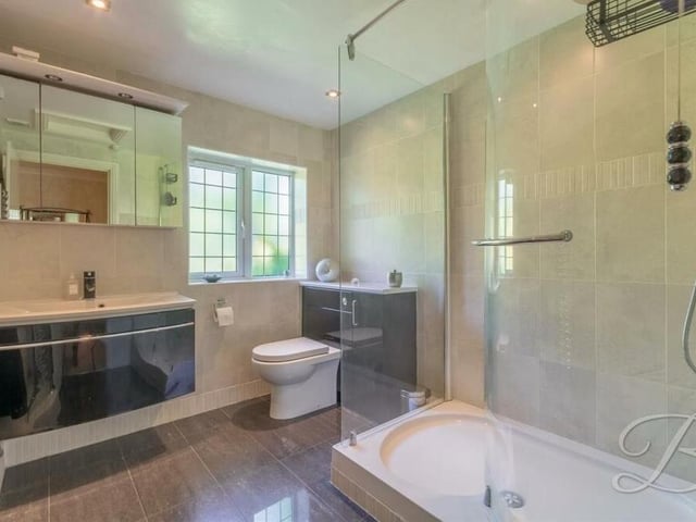 The main bedroom has the added luxury of this sleek en suite shower room. It boasts an enclosed shower, low-flush WC, wash hand basin and lots of storage space.