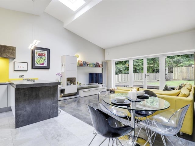 Another shot showing the open-plan living room and breakfast kitchen. Double uPVC doors open out on to a patio area in the garden.