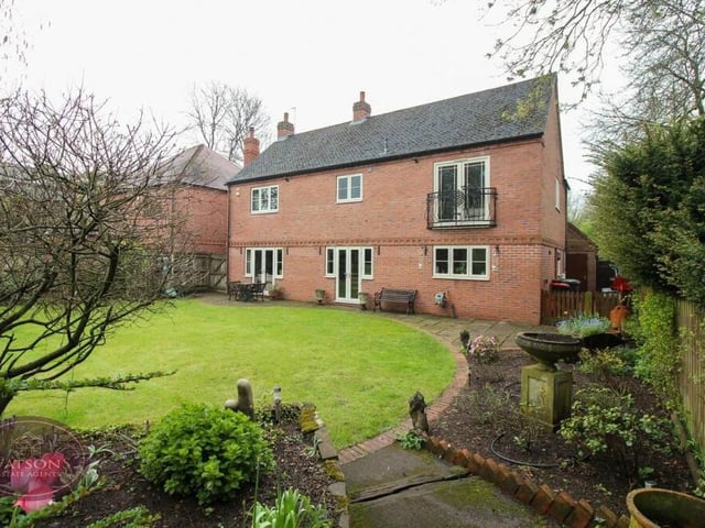 This is a good shot of the back of the house, complete with the sets of French doors downstairs and the Juliet balcony upstairs.