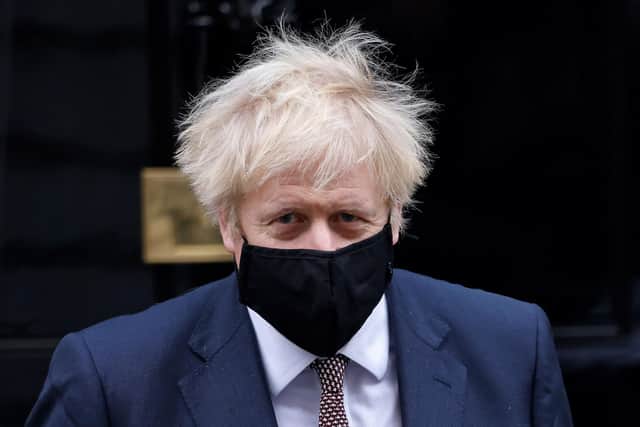 Prime Minister Boris Johnson has the final say on which areas are placed into which tier of restrictions (Photo by TOLGA AKMEN/AFP via Getty Images)