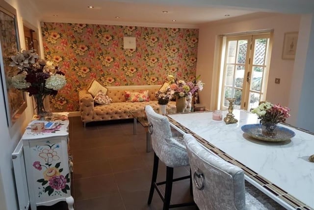 A closer look at the dining area, with its attached living space and also double-glazed, French-style doors that open out into the picturesque back garden.