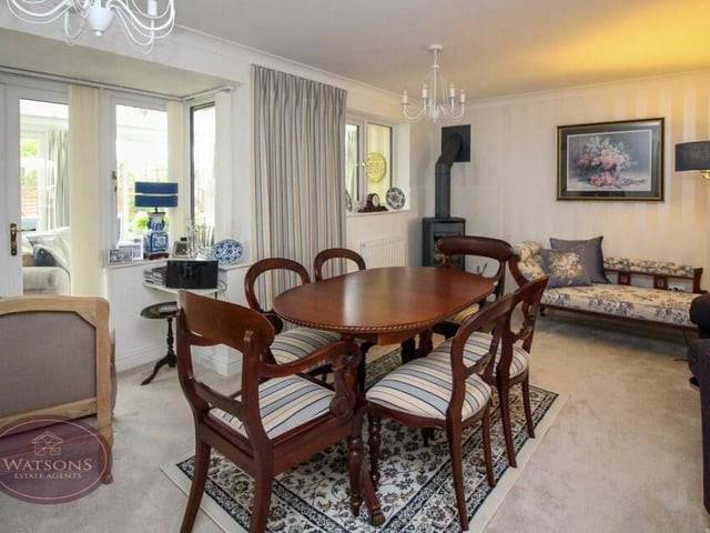 By the French doors and close to the log-burning stove in the open-plan lounge is this pleasant dining area. Perfect for family meals.