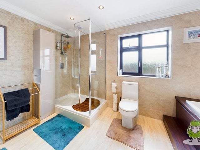 The last room to look at is this family bathroom, which is suitably equipped with full-sized bath, large shower enclosure, WC and vanity unit.