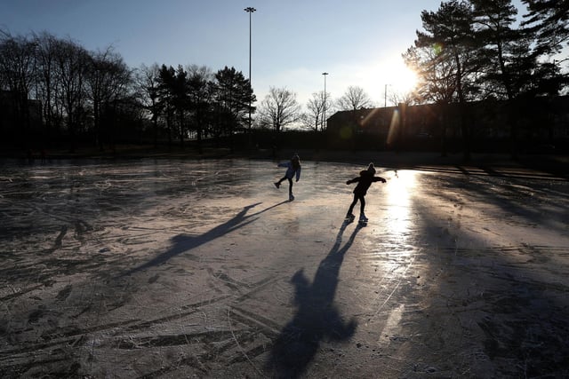People skate on a frozen pond at Victoria Park in Glasgow.