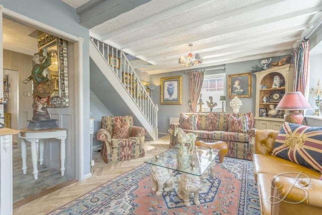 A second shot of the atmospheric and extravagantly decorated living room at the £400,000 property. It features herringbone-style flooring.