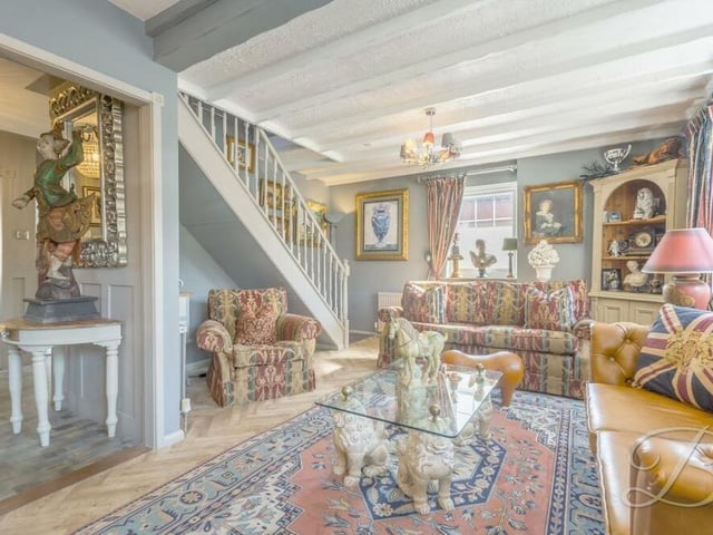 A second shot of the atmospheric and extravagantly decorated living room at the £400,000 property. It features herringbone-style flooring.