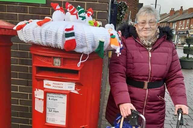 Councillor Eileen Benton with her knitted snowmen creation.