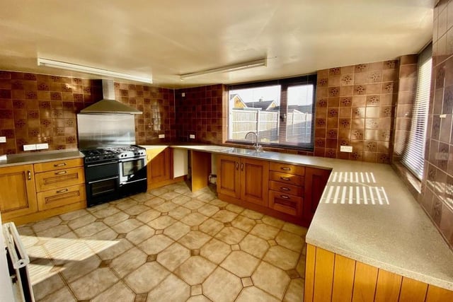 The open-plan kitchen is the largest room in the bungalow when combined with its dining area and extra living space. It features a range cooker with chrome splashback and hood extractor fan over, and there is space for further appliances, as well as plumbing for a washing machine.