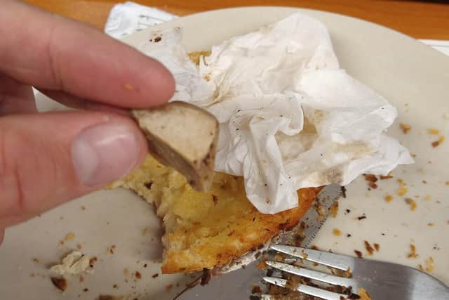 Paul Hand holds the bone that he found in the Sainsbury's steak slice he was eating for lunch.